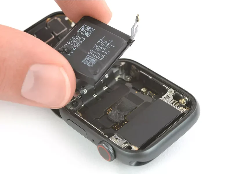 Apple Watch battery replacement process in Ajman showing tools and technician.