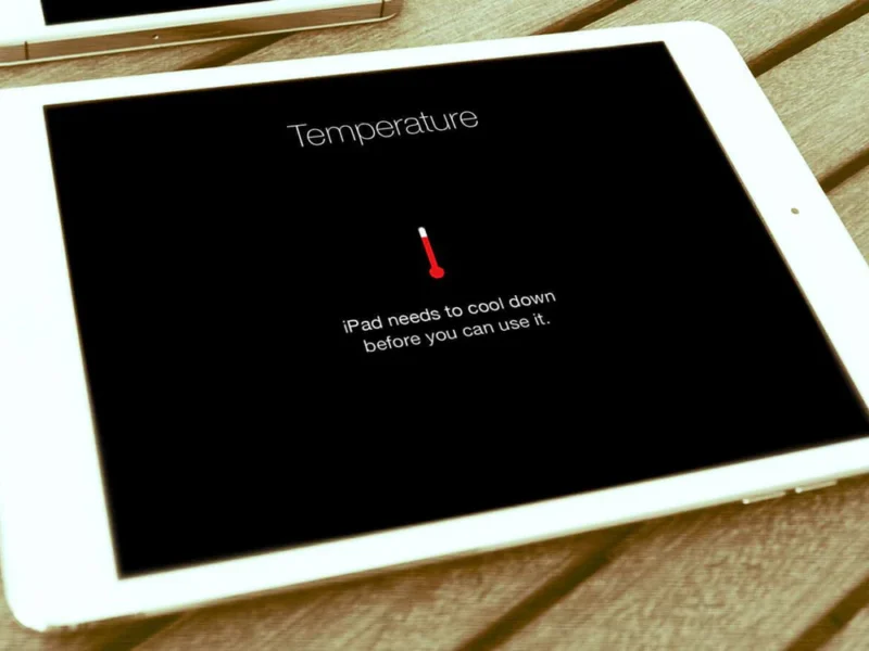 Overheated iPad on a desk with user learning how to cool it down.