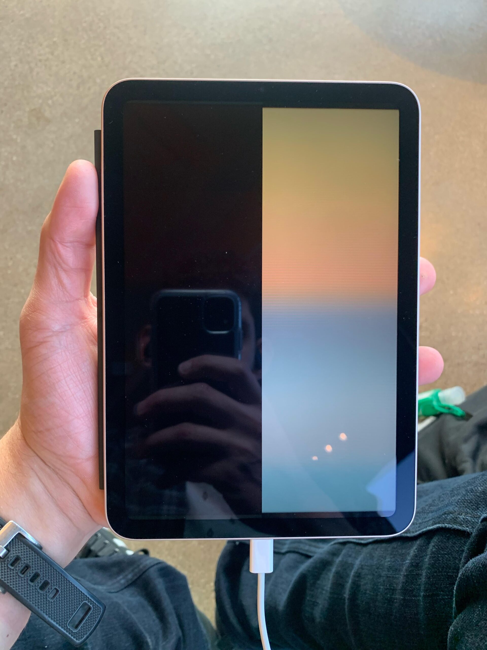 Technician fixing an iPad display that is dim or black in Dubai