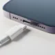 Technician repairing iPhone 13 charging port in Dubai.