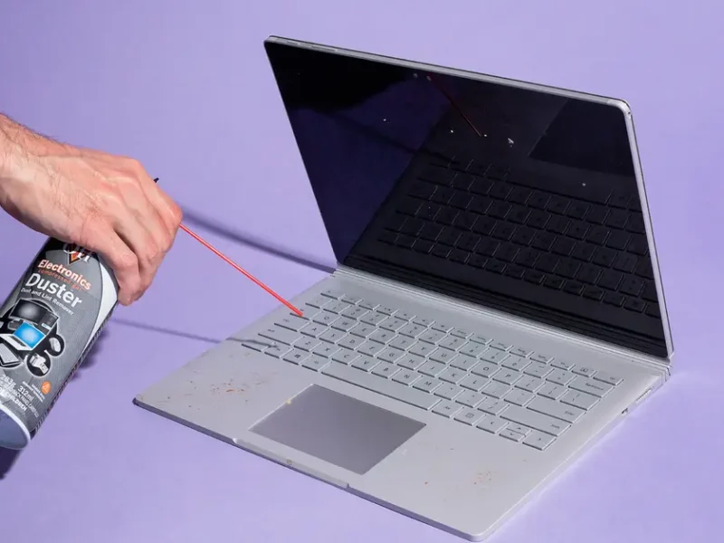 Technician performing laptop cleaning and maintenance in Ajman at Milaaj Mobile and Laptop Repair Dubai.