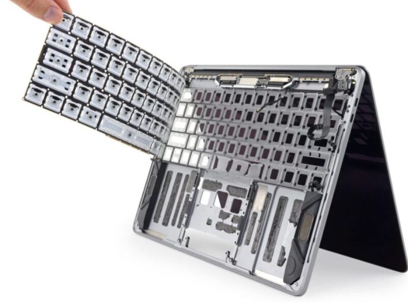 Technician performing MacBook keyboard repair in Ajman using genuine parts