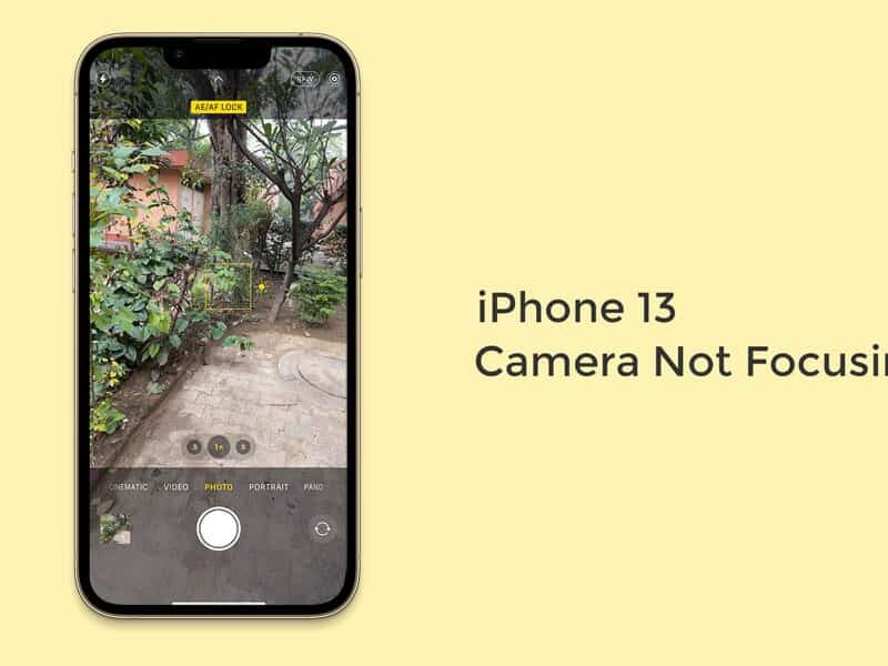 Technician fixing iPhone 13 camera blurry or not focusing issue at a repair shop.