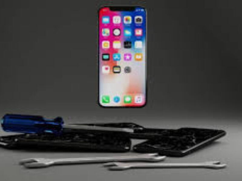 Technician at Milaaj mobile and laptop repair Dubai fixing a modular ASUS laptop motherboard.