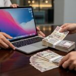 A clean, silver MacBook Pro open on a table in a Dubai coffee shop